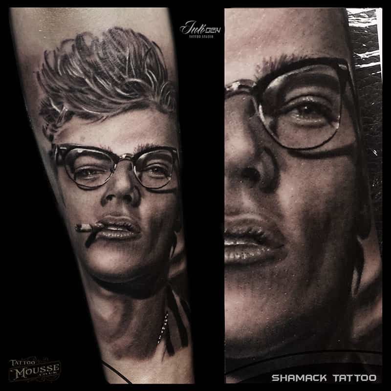 Black-and-gray tattoo design of a man with glasses, shown in two close-up portrait panels