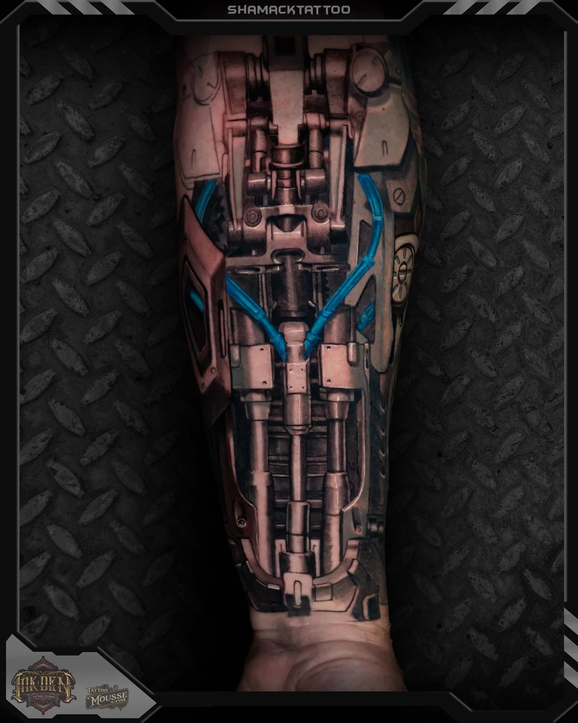 Close-up of a cybernetic leg implant with exposed metal parts and blue tubing on a dark textured background