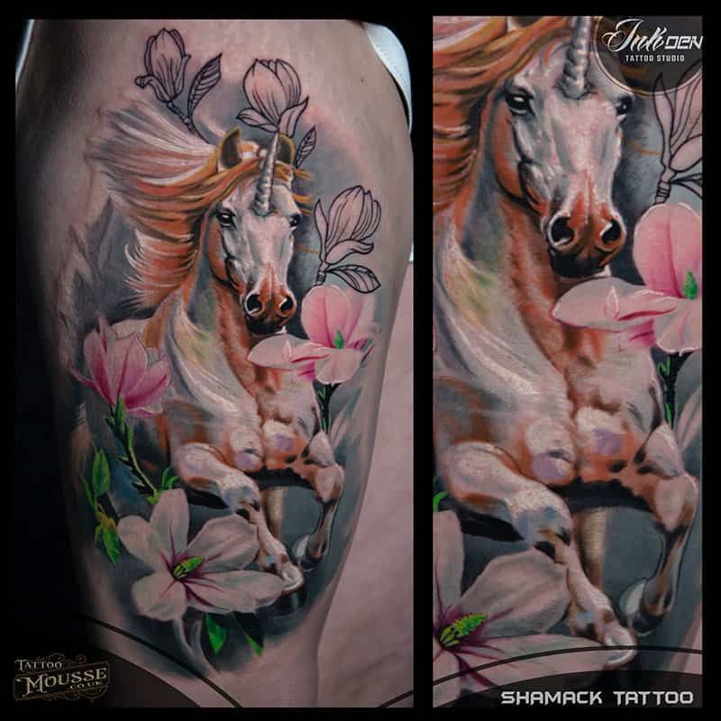 Tattoo of a white horse among pink flowers on a calf, shown in two close-up views