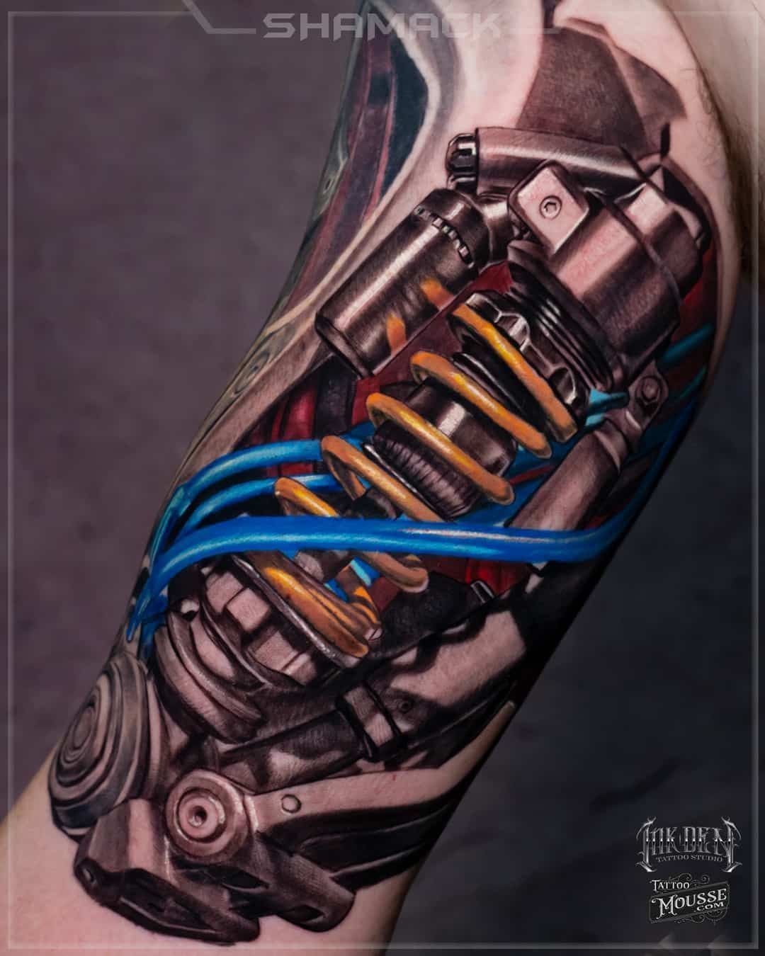 spring-yellow-biceps-realism-3d-Black-and-grey-cyber-biomechanical-tattoo-Shamack-Inkden